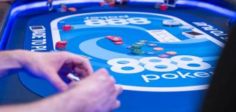 Players around an 888poker table during a live poker game